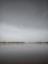 a large body of water sitting under a cloudy sky