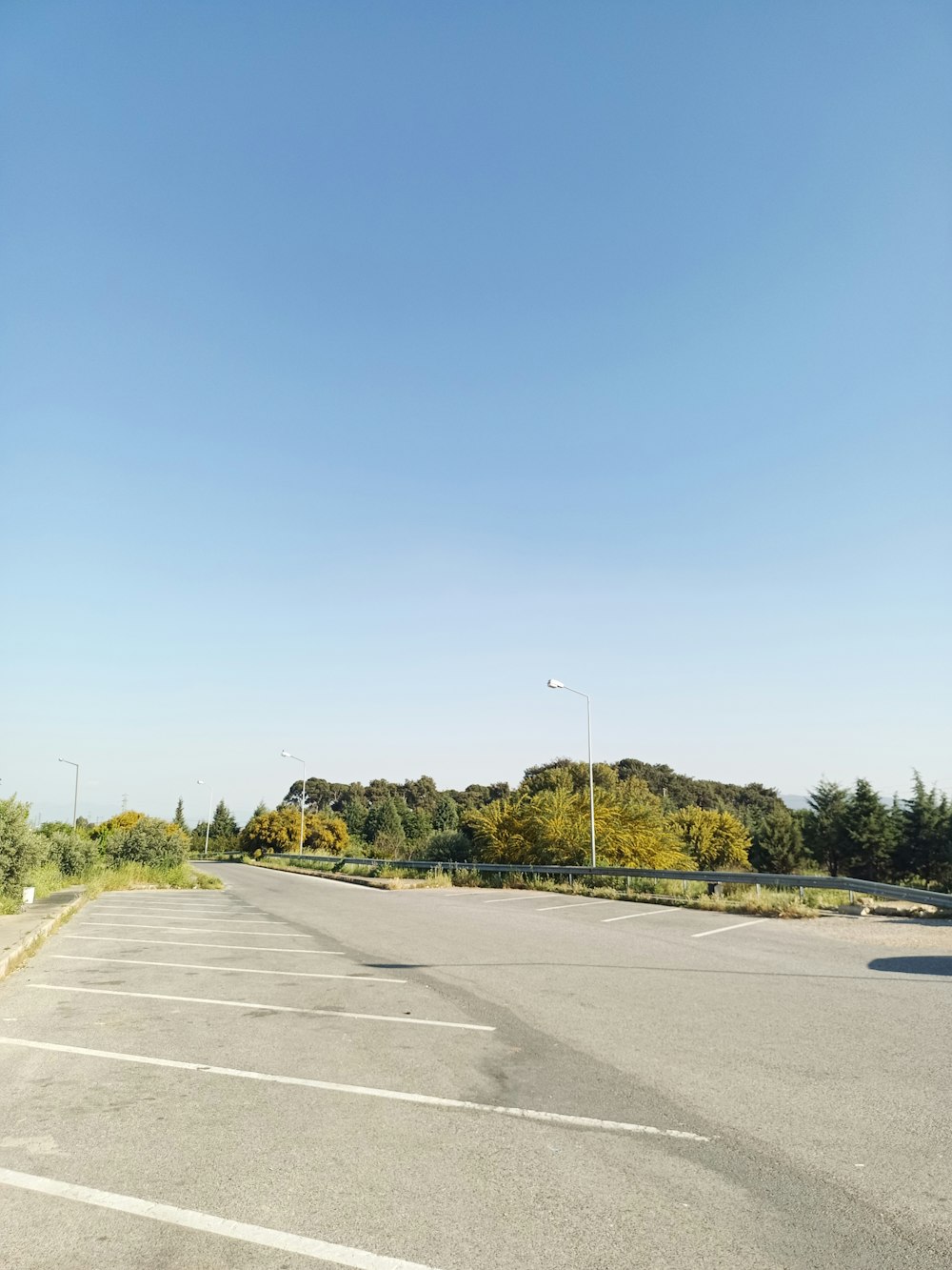 a empty parking lot with a blue sky in the background