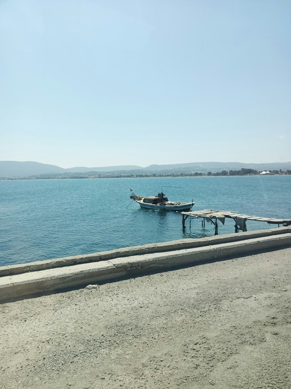 a boat sitting on top of a large body of water