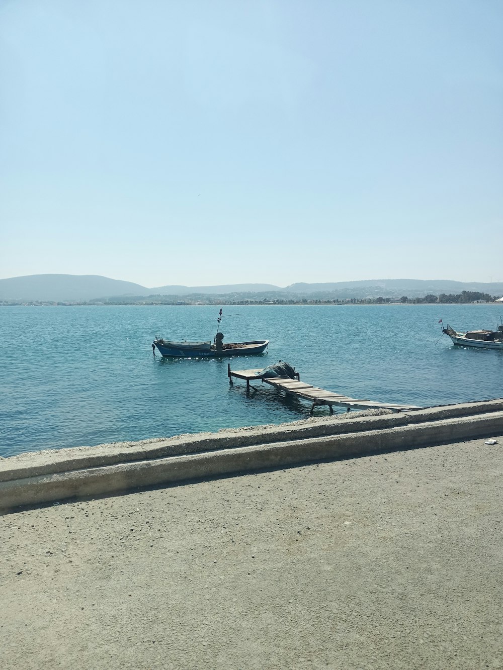 a group of boats floating on top of a large body of water