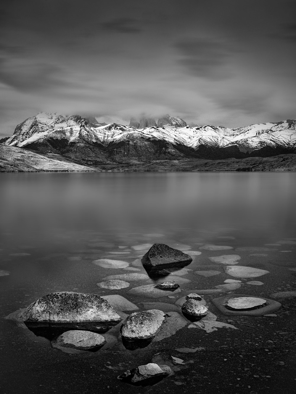 a black and white photo of a mountain lake