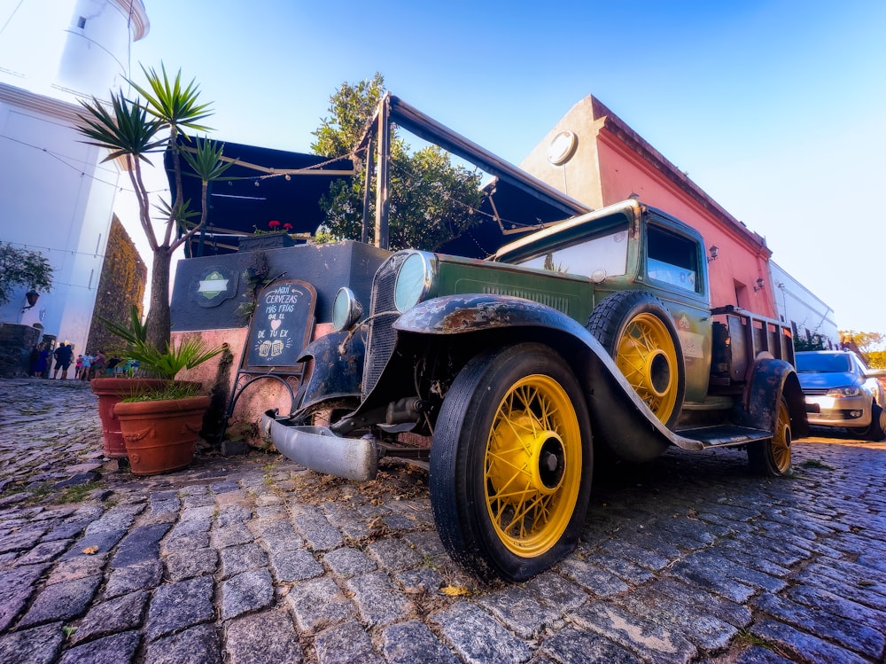 an old car is parked in front of a building