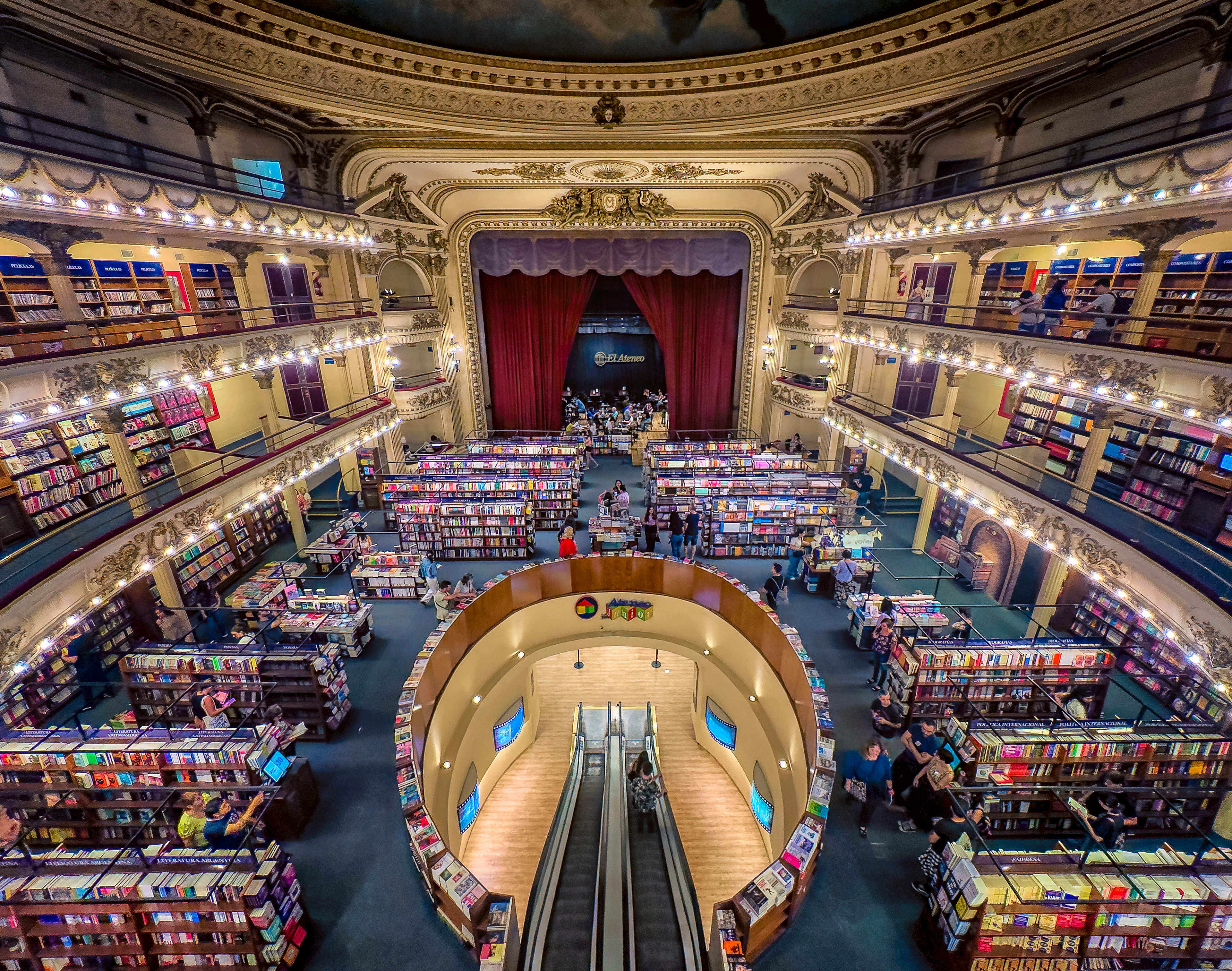 The El Ateneo Grand Splendid bookshop, a converted theatre with gilded balconies of books and the original red stage curtain