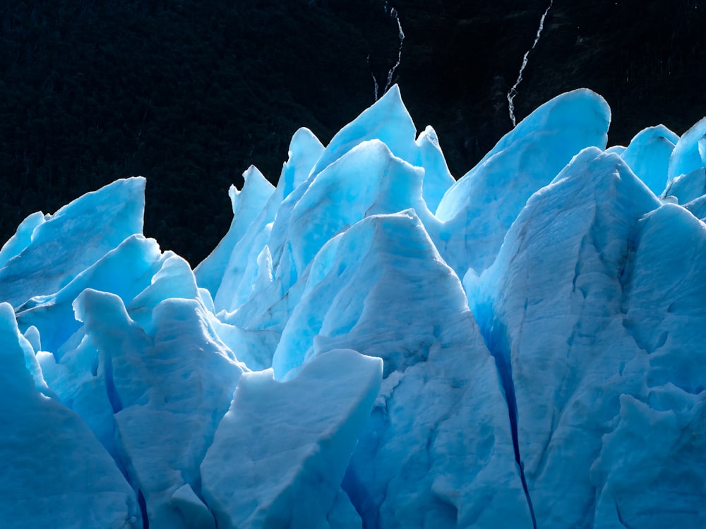 a large blue glacier with lots of snow on it