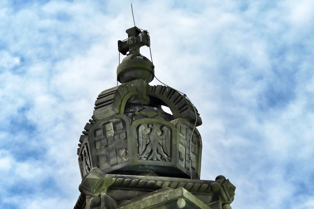 a clock tower with a weather vane on top