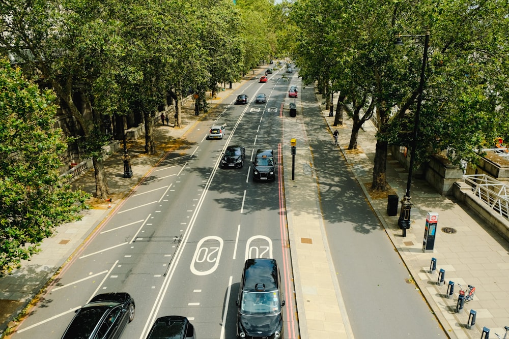 an aerial view of a city street with cars driving down it