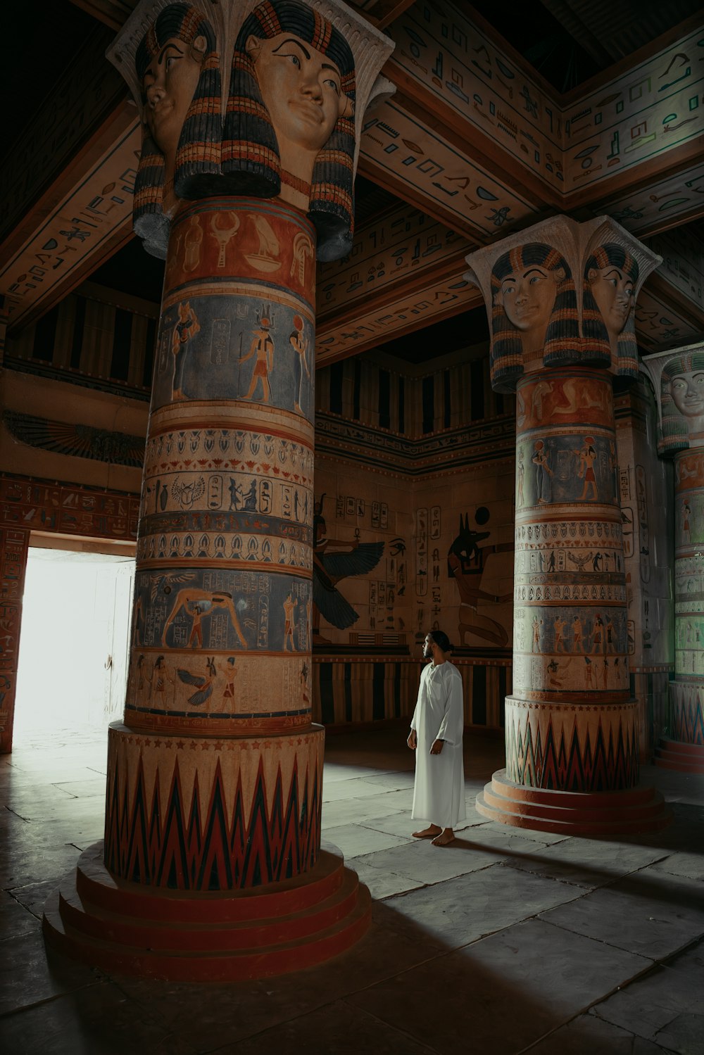 a person standing in a room with columns