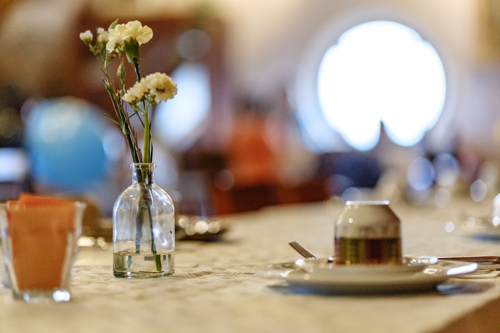 a table topped with a vase filled with flowers