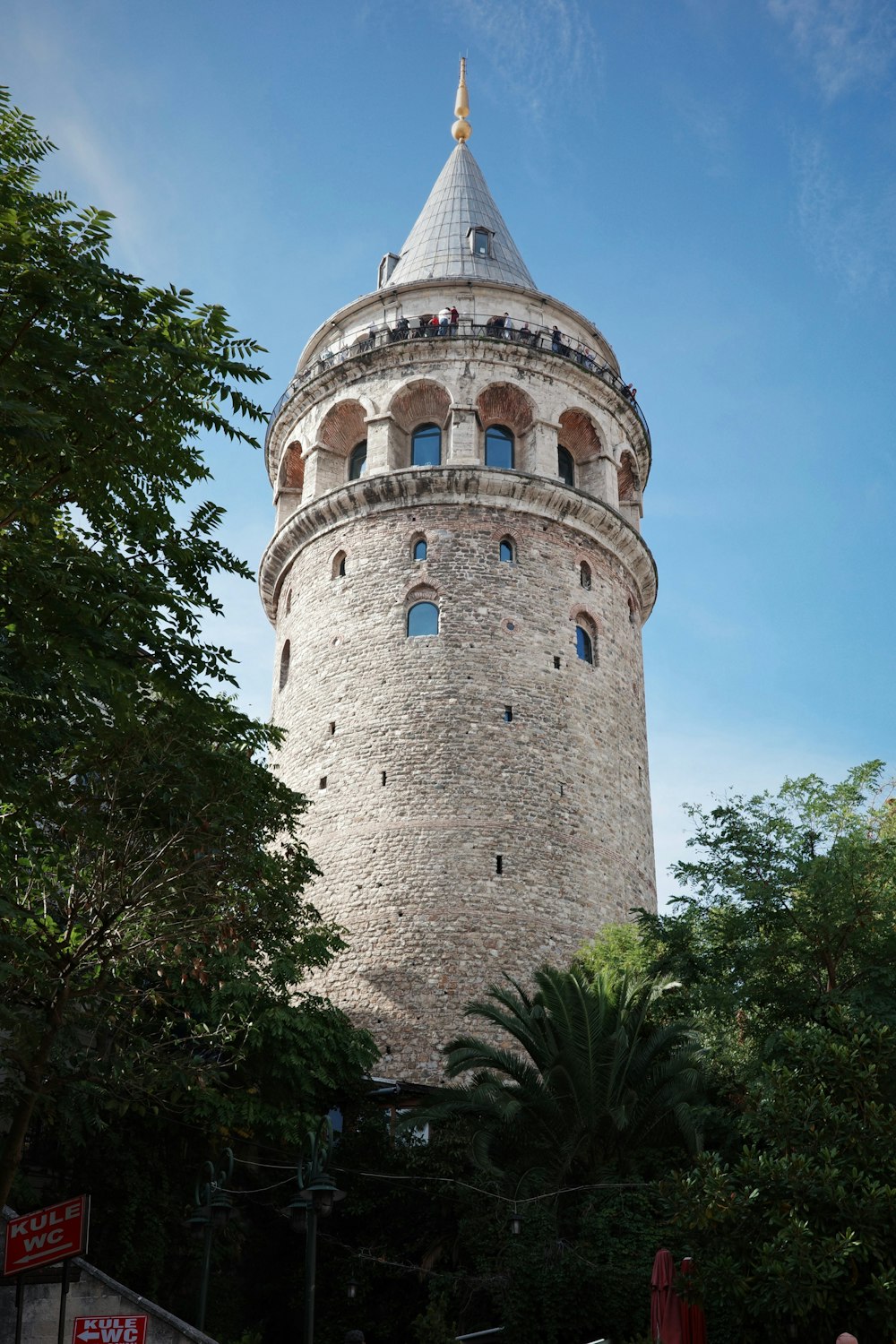 a very tall tower with a clock on it's side