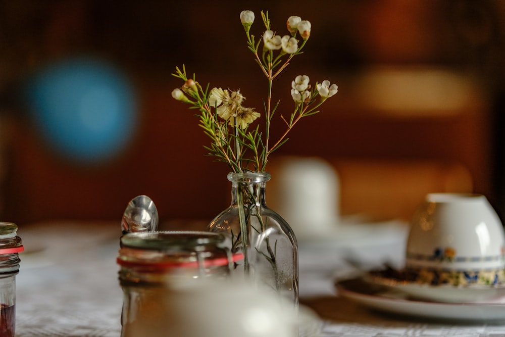 a table topped with a vase filled with flowers