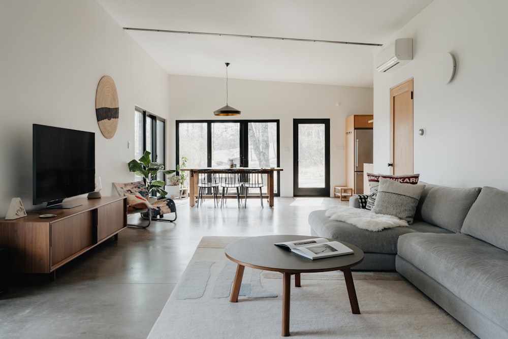 a living room filled with furniture and a flat screen tv