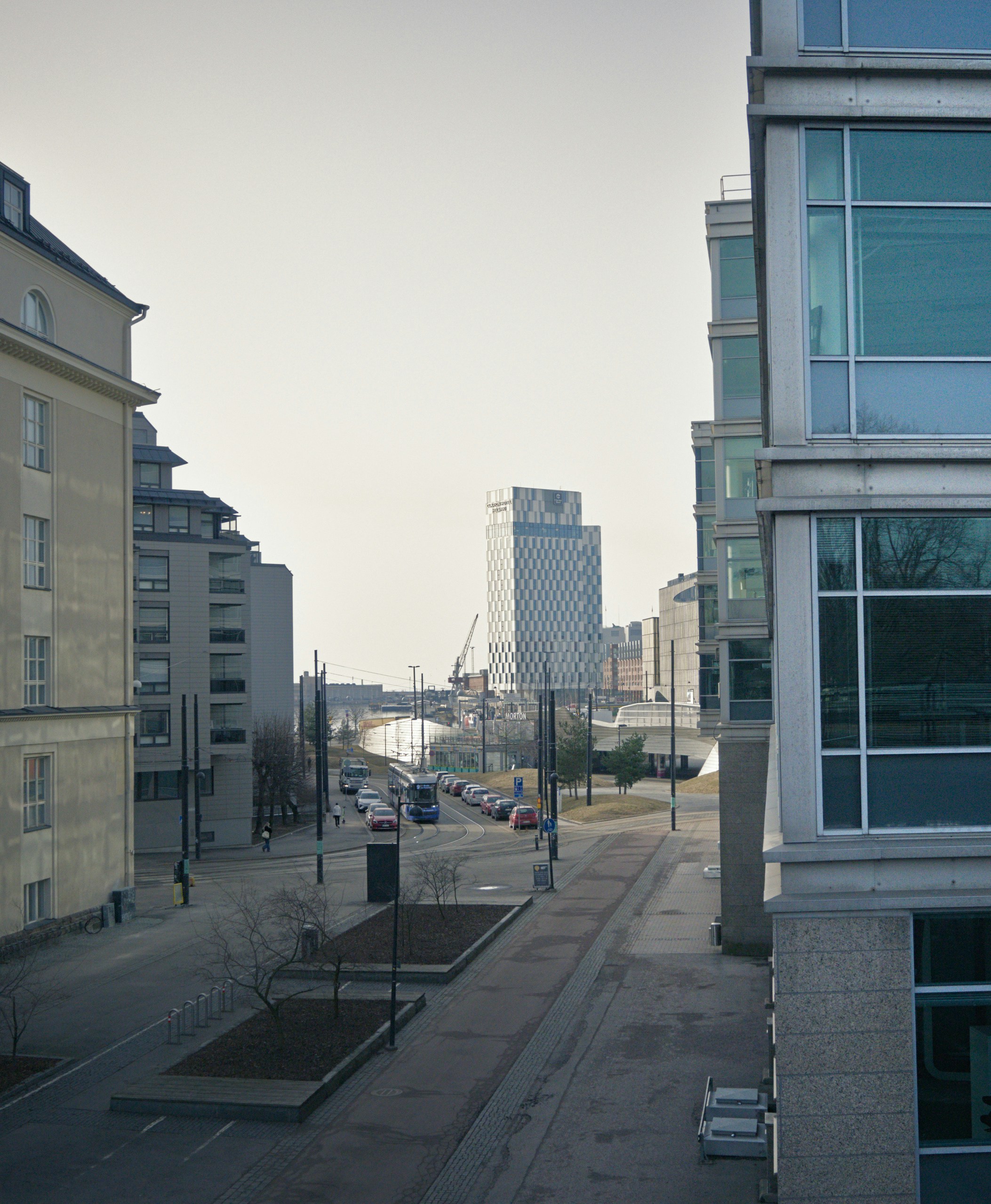 A view of a city street with buildings in the background photo – Free ...