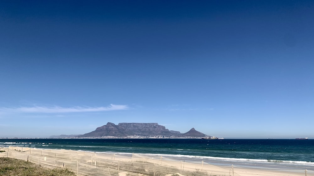 a view of a beach with a mountain in the background