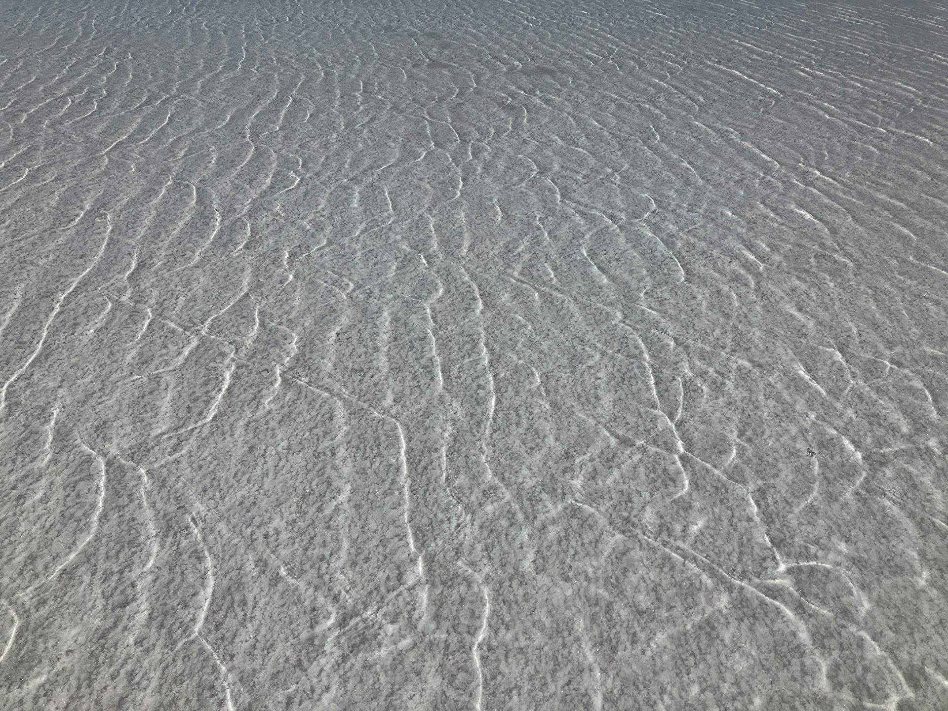 a snow covered field with a sky in the background