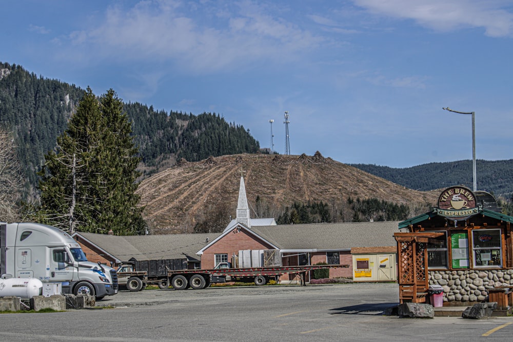 a truck parked in a parking lot next to a building