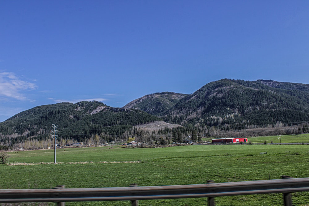 a green field with mountains in the background