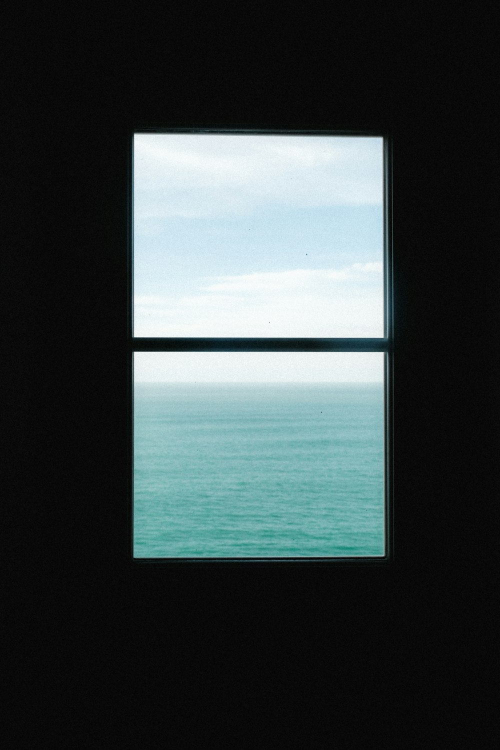 a window with a view of the ocean