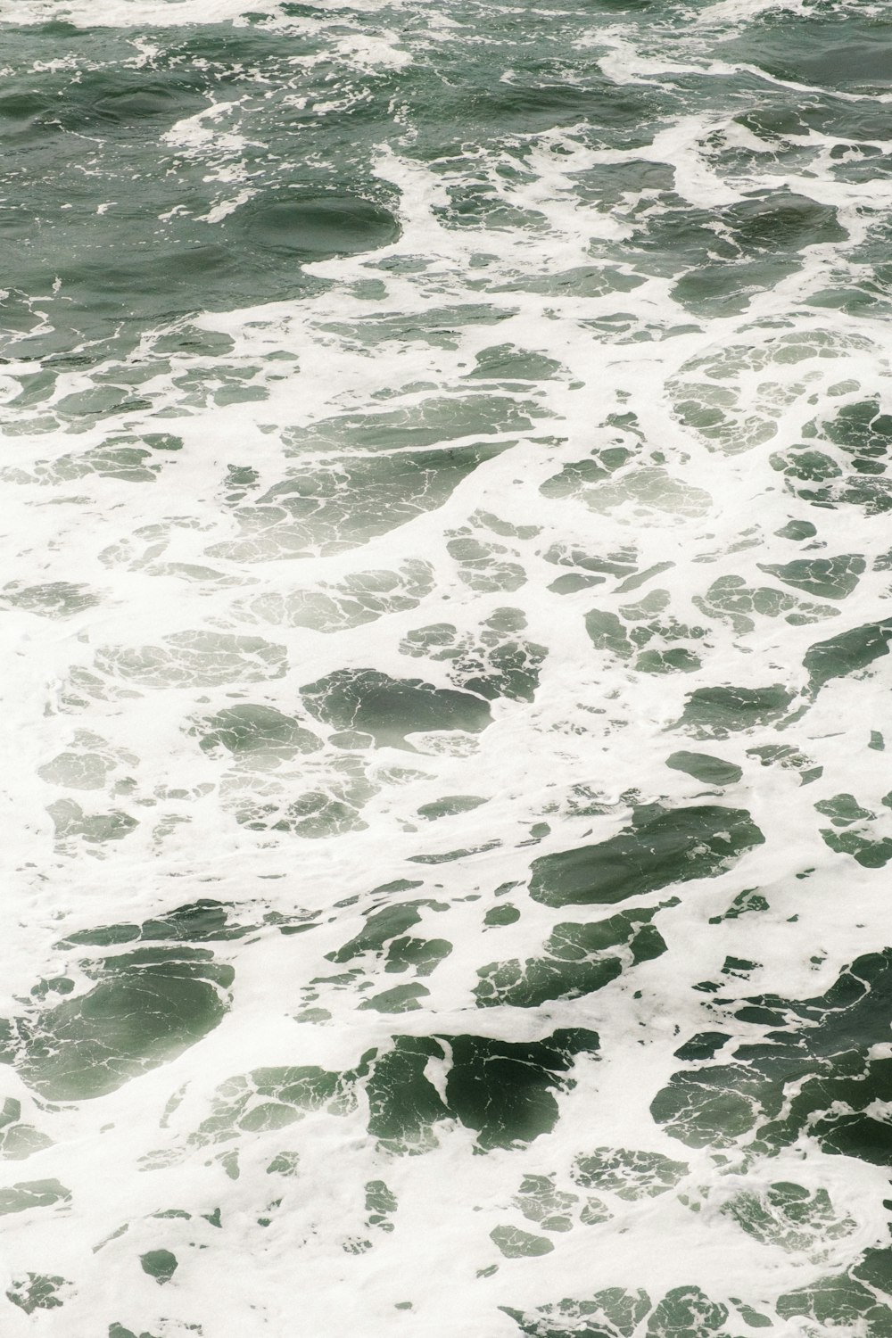 a man riding a surfboard on top of a wave in the ocean