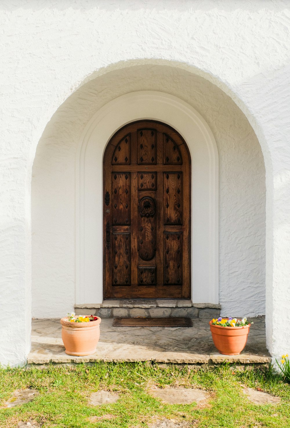 two pots of fruit sit in front of a door