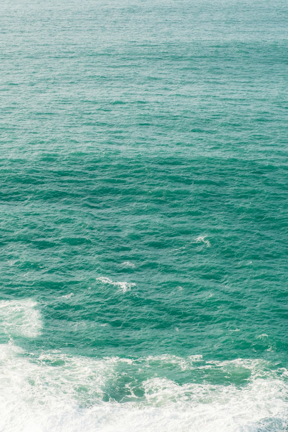 a man riding a surfboard on top of a wave in the ocean