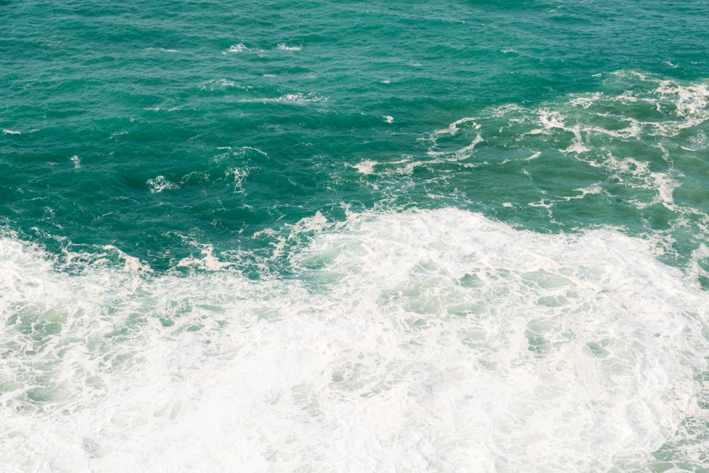 a person riding a surfboard on top of a wave