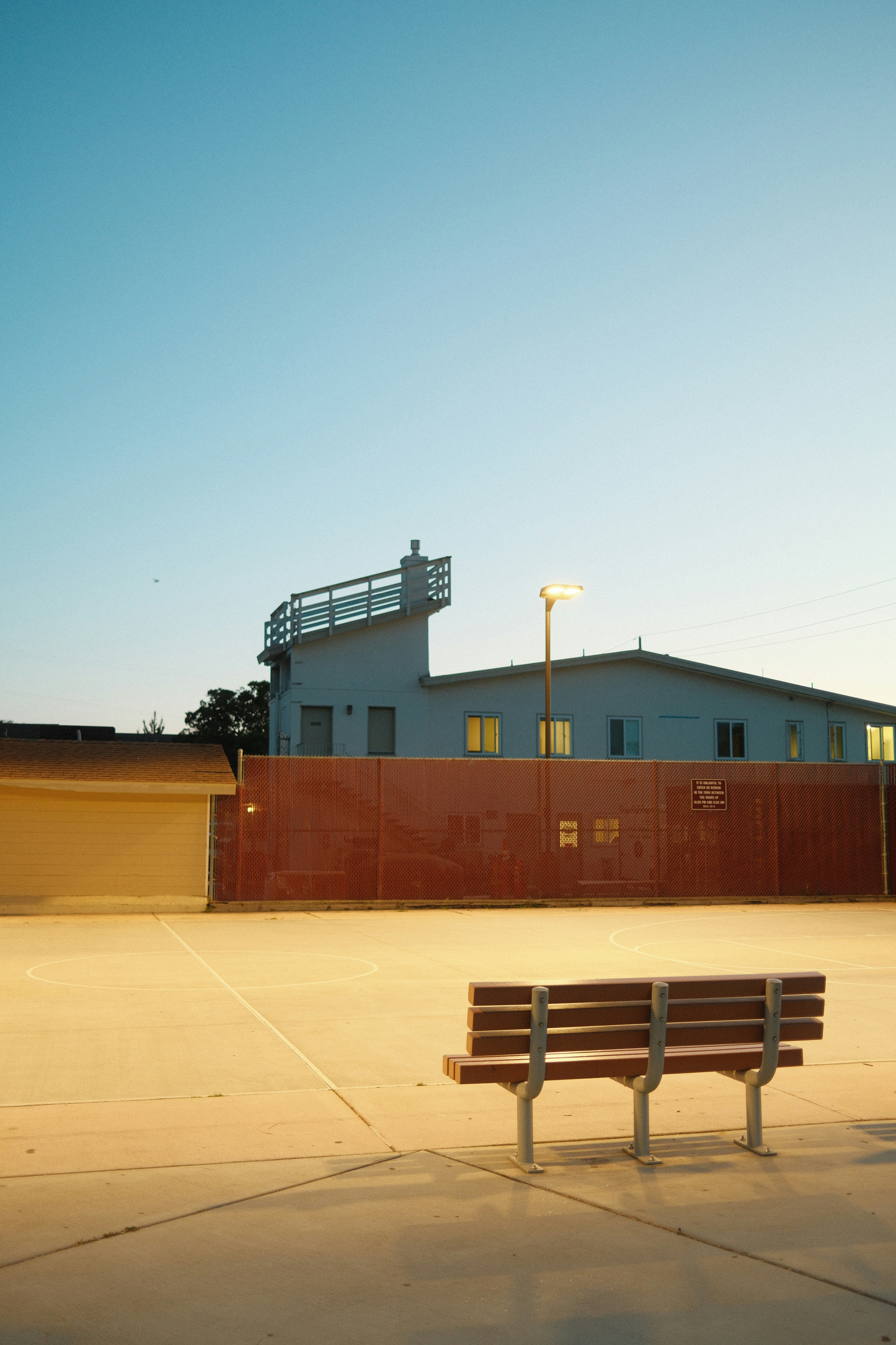 A wooden bench sitting in front of a building photo – Free Bench Image ...