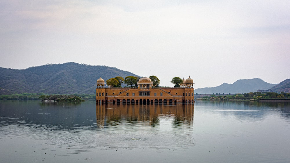 a large building sitting on top of a lake