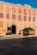 a large building with a potted plant in front of it