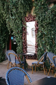 a table with blue chairs and a mirror on the wall