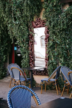 a table with blue chairs and a mirror on the wall