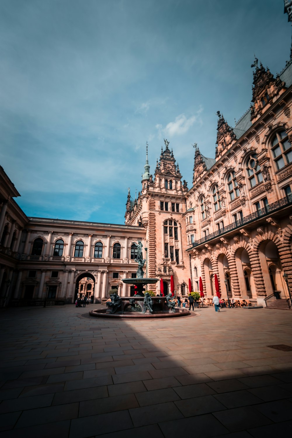 ein großes Gebäude mit einem Springbrunnen davor