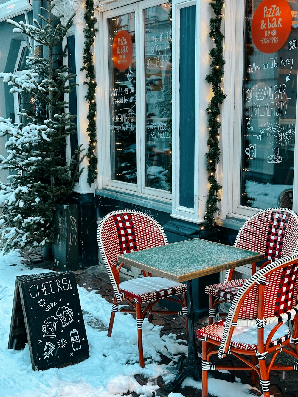 a couple of red chairs sitting next to a table