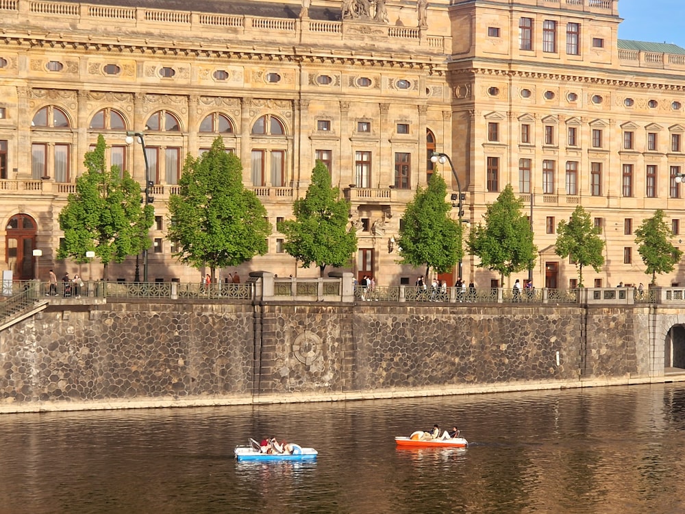 a couple of small boats floating on top of a river