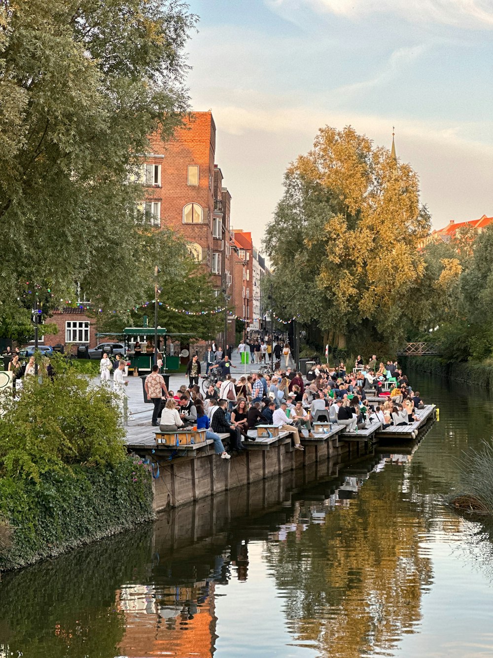 a group of people riding on top of a boat down a river