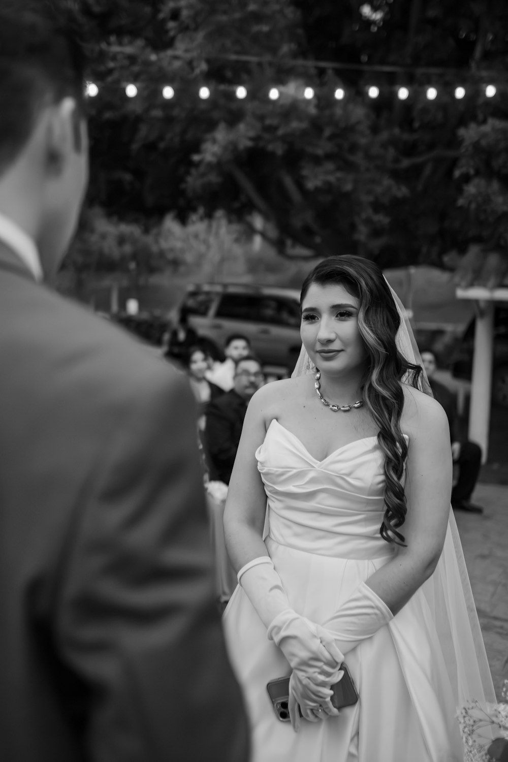 a woman in a wedding dress standing next to a man in a suit