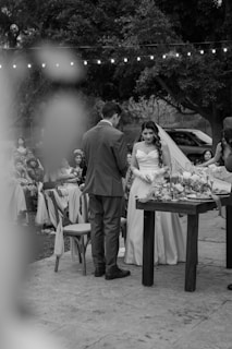 a bride and groom standing at a table
