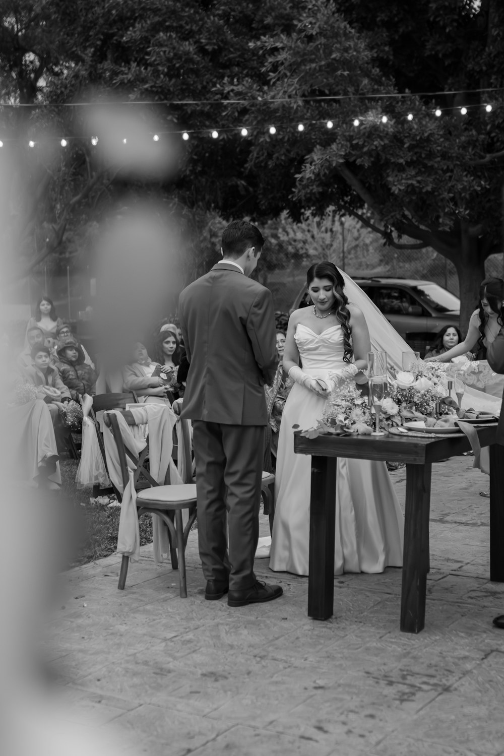 a bride and groom standing at a table