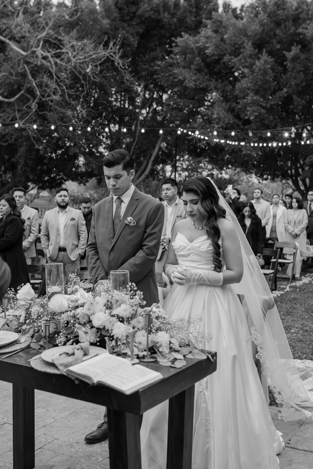 a bride and groom are standing at a table