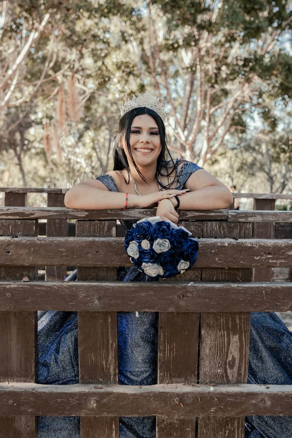 a woman sitting on a bench with a bouquet of flowers