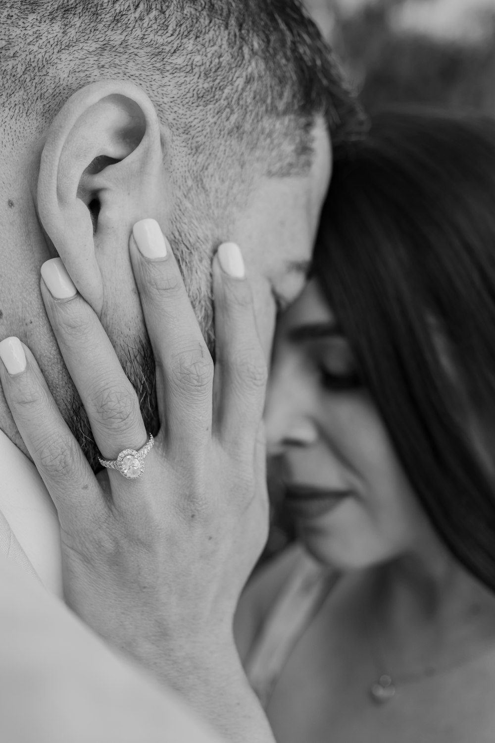 a man and woman holding their hands to their ears