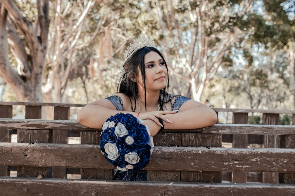 a woman sitting on a bench with her arms crossed