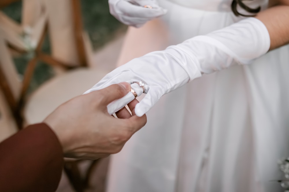 a couple of people that are wearing white gloves