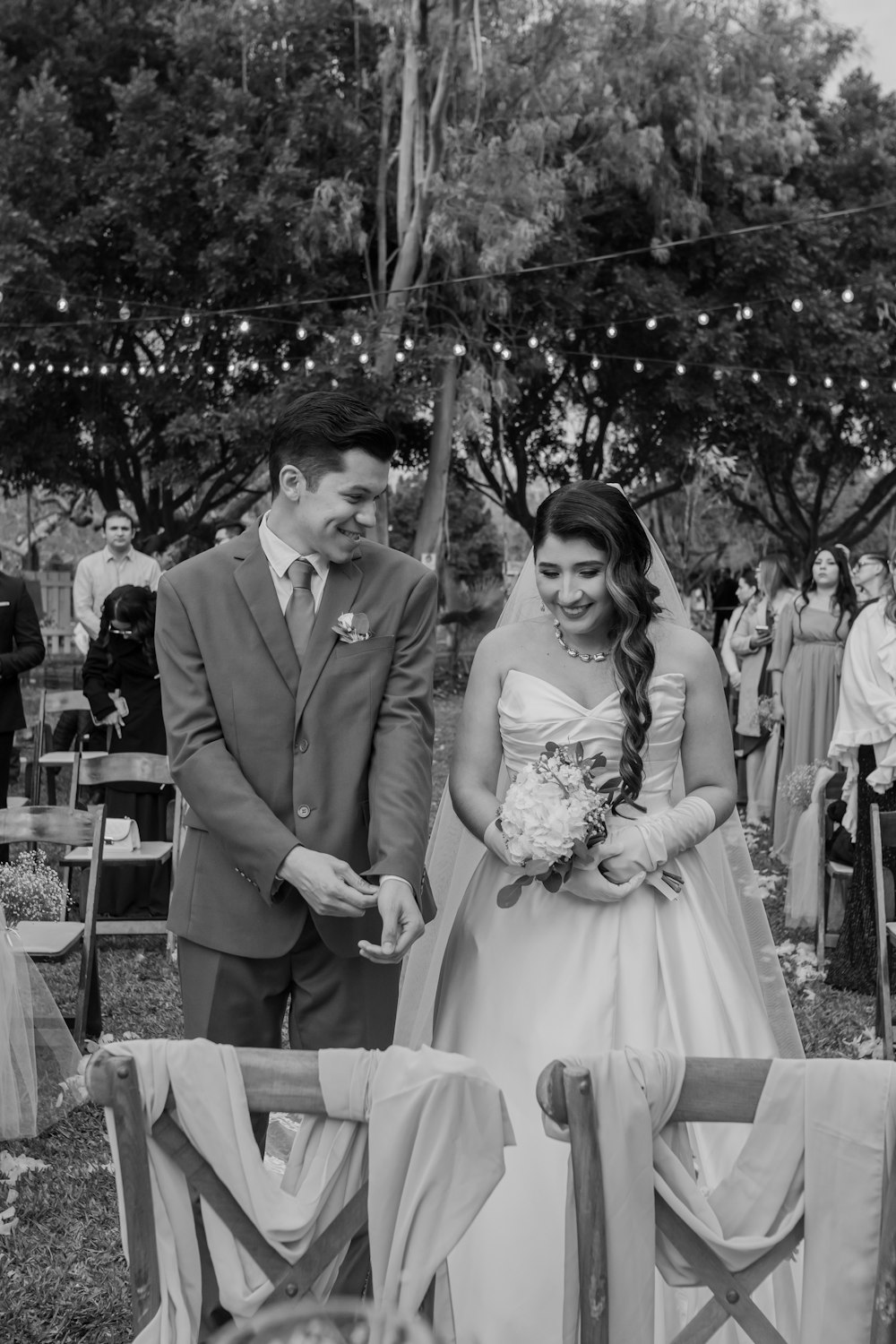 a bride and groom walking down the aisle