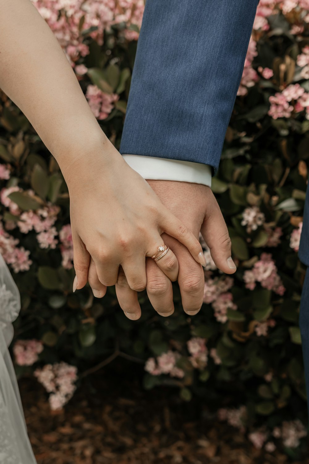 a close up of two people holding hands