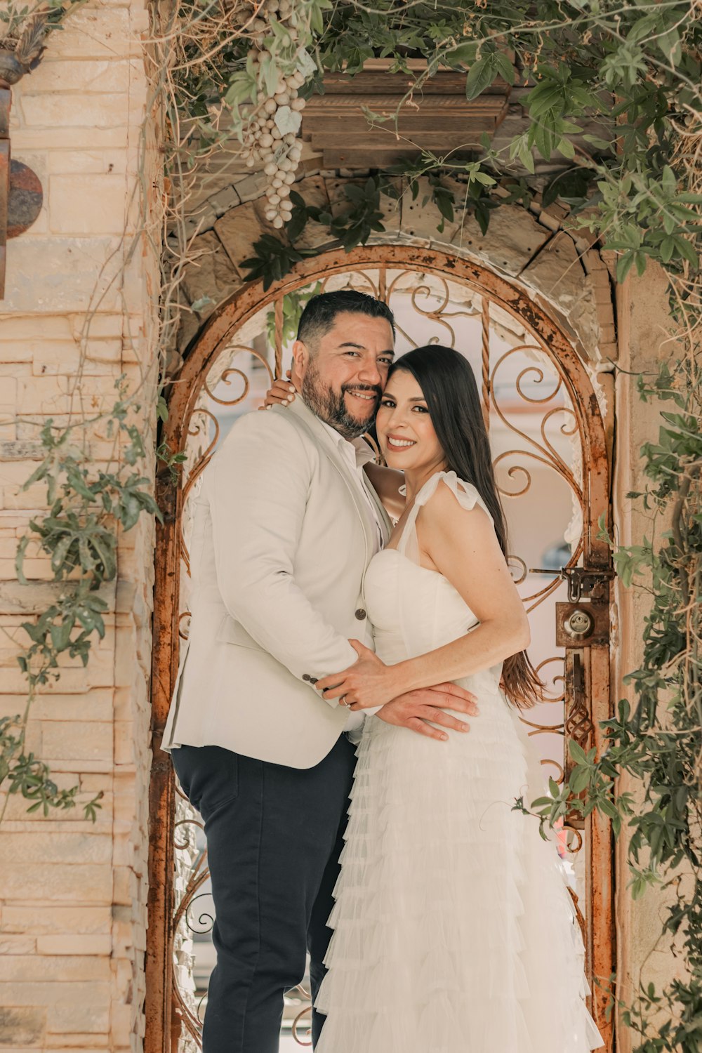 a bride and groom pose for a wedding photo