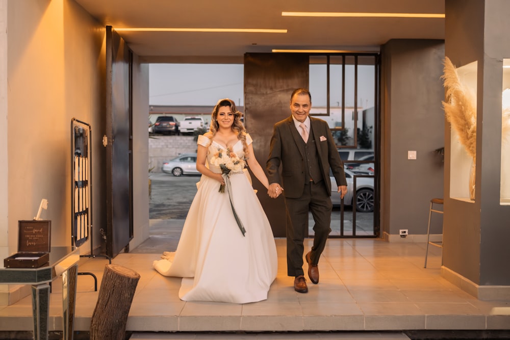 a bride and groom walking down the aisle