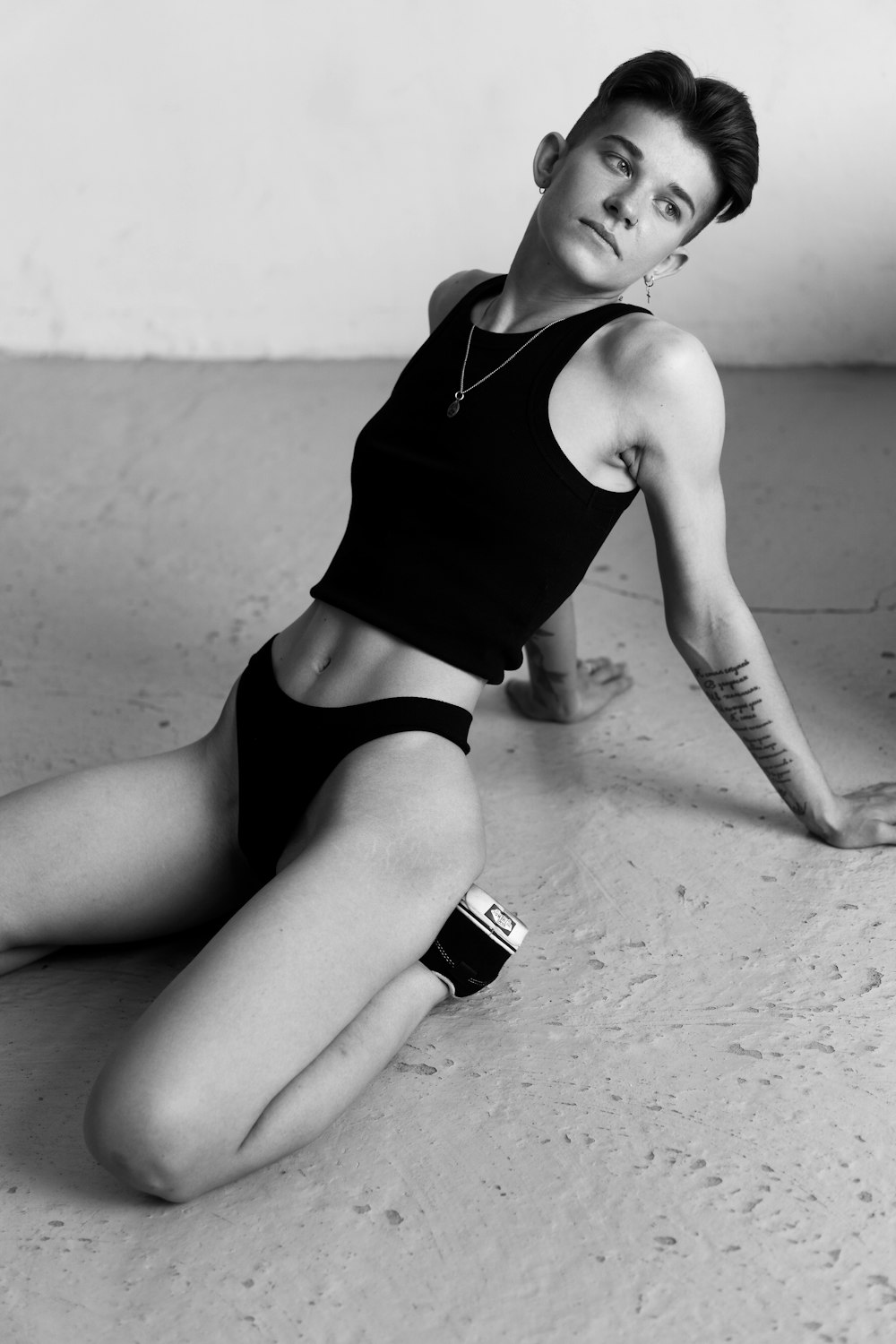 a black and white photo of a woman laying on the ground