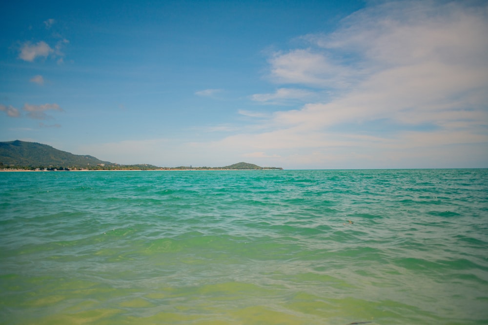 a body of water with a small island in the distance