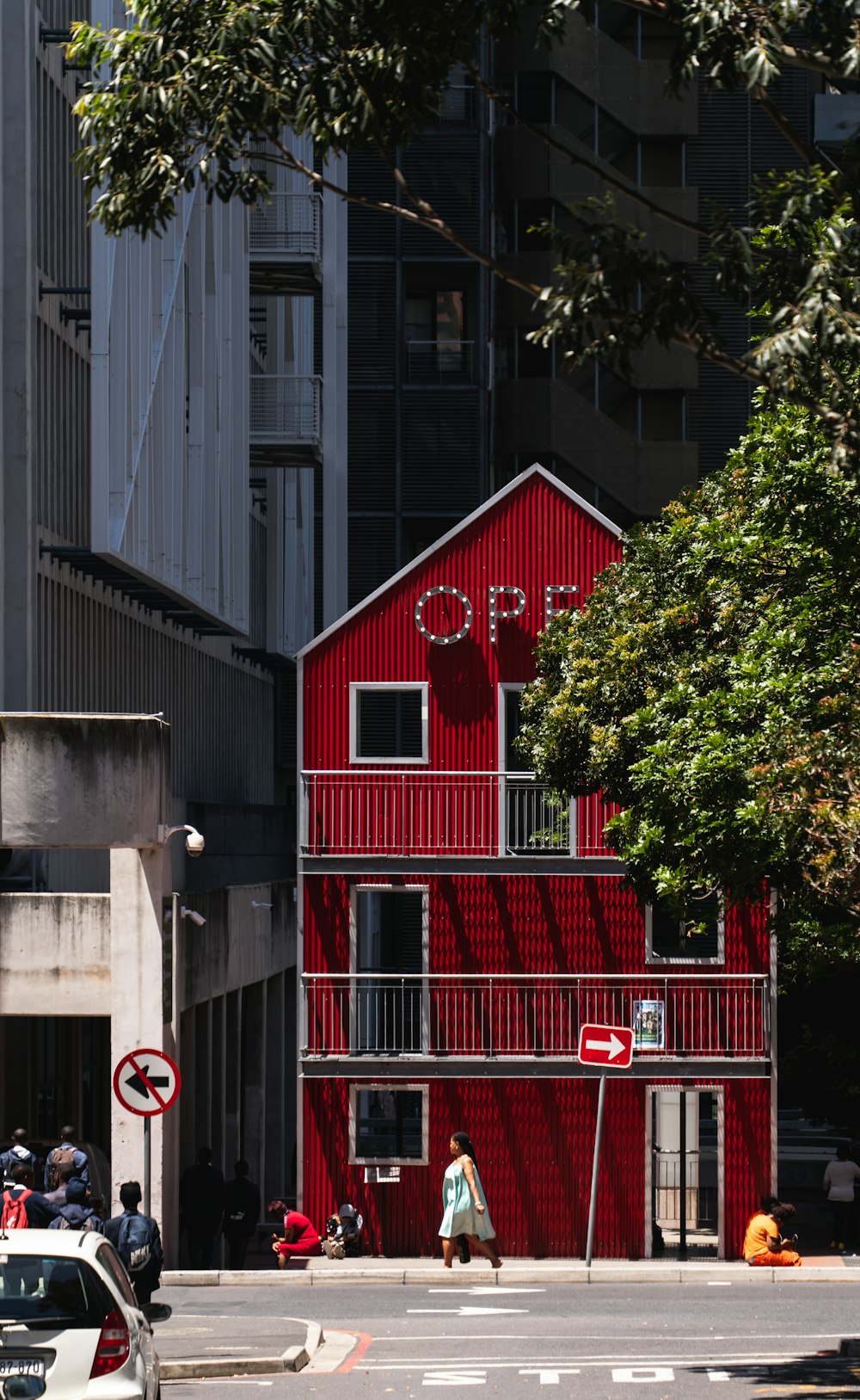 a red building on a city street next to tall buildings