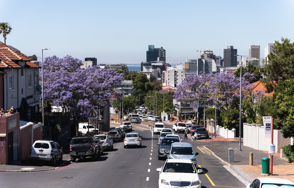 a street filled with lots of traffic next to tall buildings